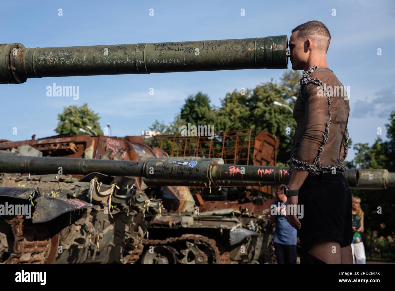 Kyiv, Ukraine. 15th July, 2023. A tourist looks inside a barrel of a destroyed Russian tank on display for public at the exhibition of destroyed Russian military vehicles in Kyiv. Credit: SOPA Images Limited/Alamy Live News Stock Photo