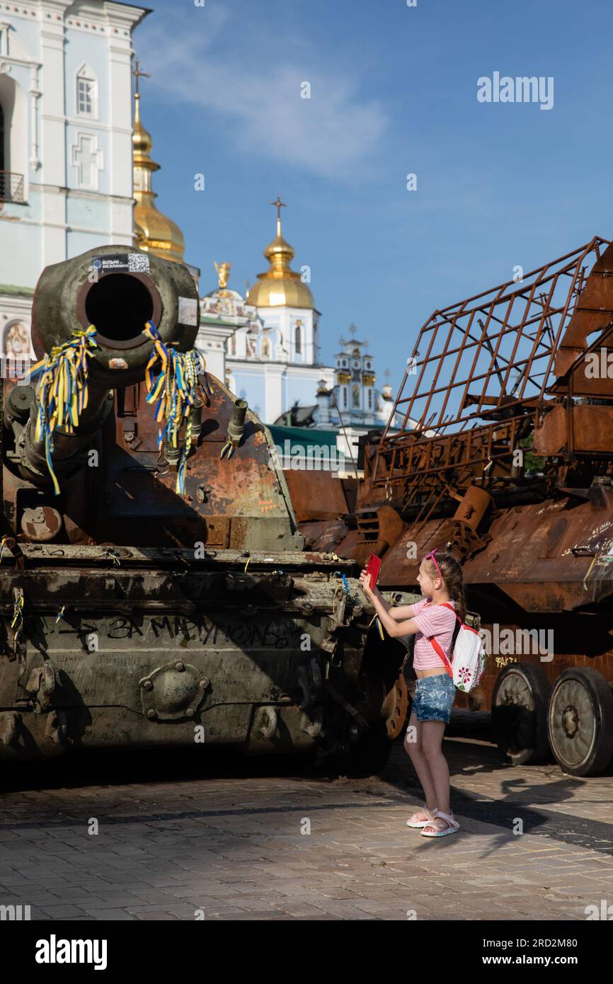 Kyiv, Ukraine. 15th July, 2023. A kid takes a photo of a destroyed Russian tank on display for public at the exhibition of destroyed Russian military vehicles in Kyiv. Credit: SOPA Images Limited/Alamy Live News Stock Photo