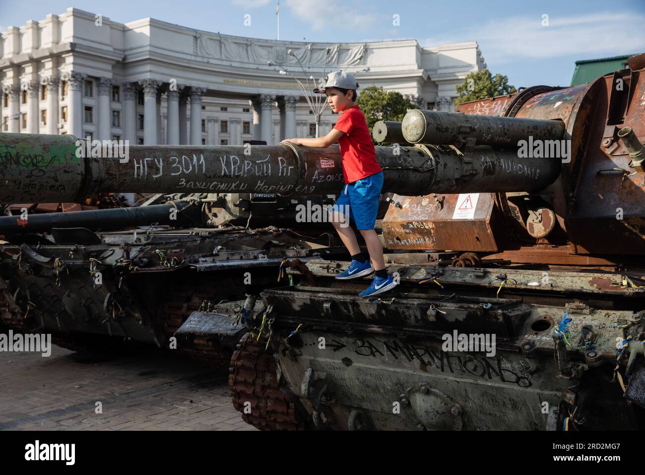 Kyiv, Ukraine. 15th July, 2023. A kid stands on top of a destroyed Russian tank on display for public at the exhibition of destroyed Russian military vehicles in Kyiv. Credit: SOPA Images Limited/Alamy Live News Stock Photo