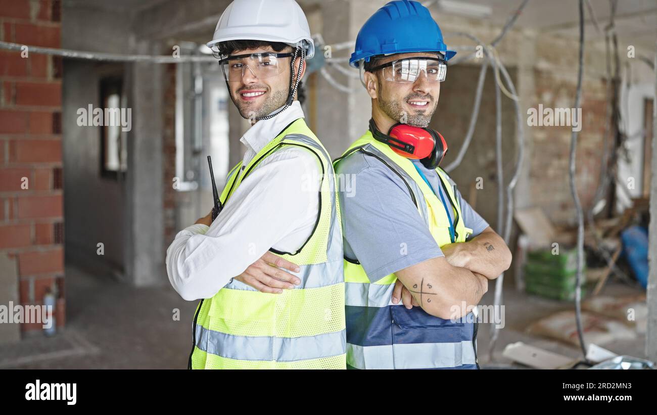Two men builders standing arms hi-res stock photography and images - Alamy