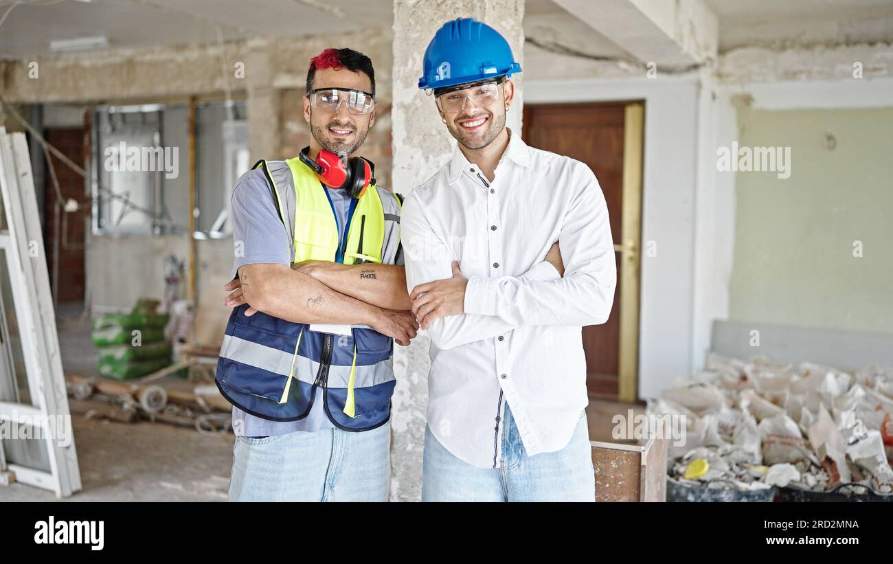 Two men builder and architect smiling confident standing with arms ...