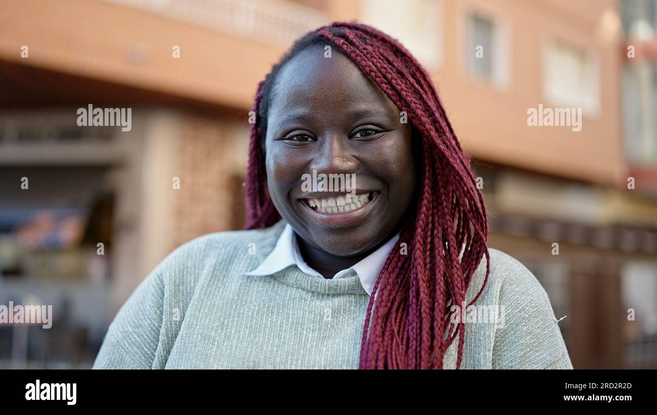 African woman with braided hair smiling confident at street Stock Photo ...