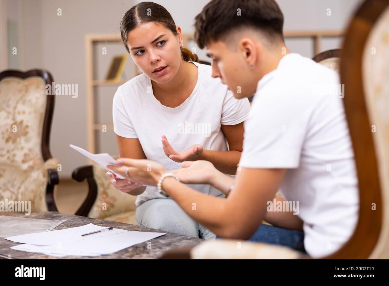 Realtor helping young man fill out paperwork stock photo alamy
