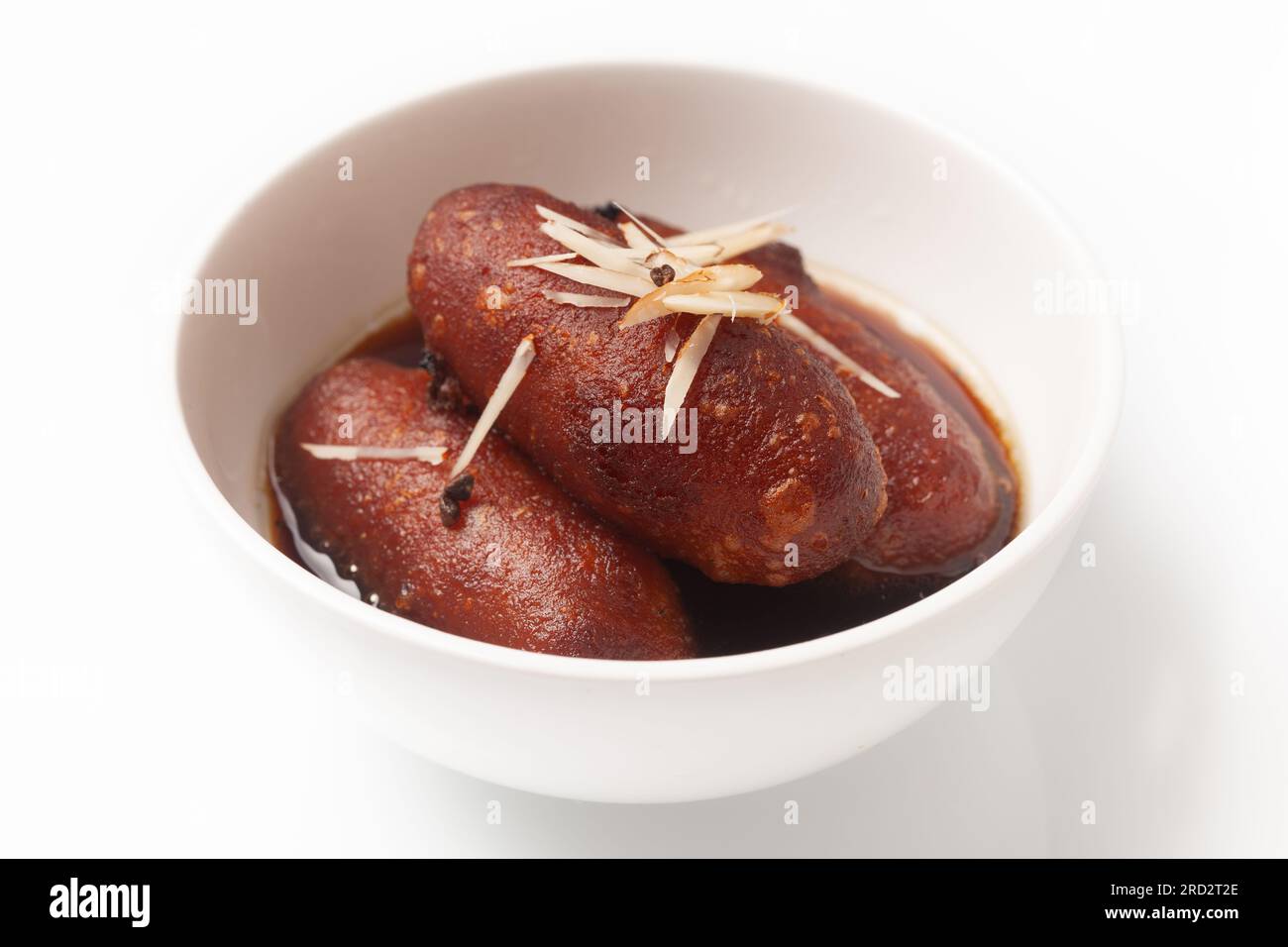 Close-up of Indian Bangali traditional sweet dish Pitha or Peetha ( Roshopuli ) made from red sweet potato, garnished with chopped almond and dry nuts Stock Photo