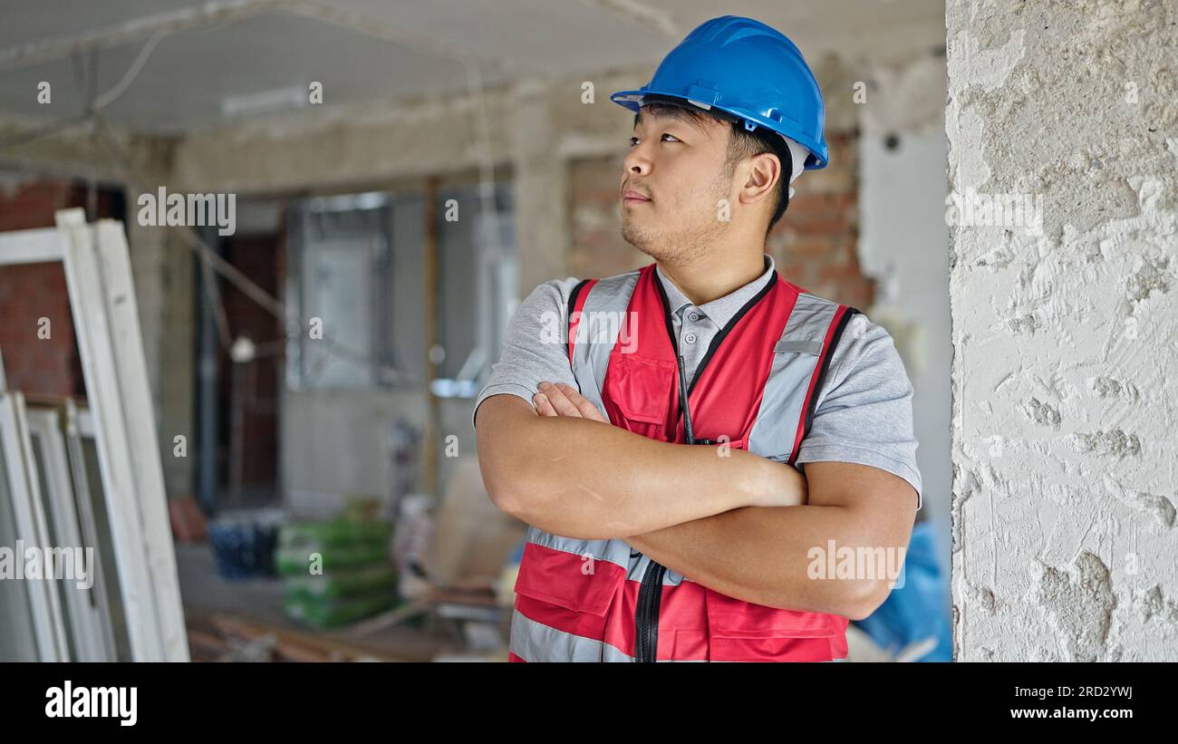 builder standing with arms crossed gesture looking around at ...