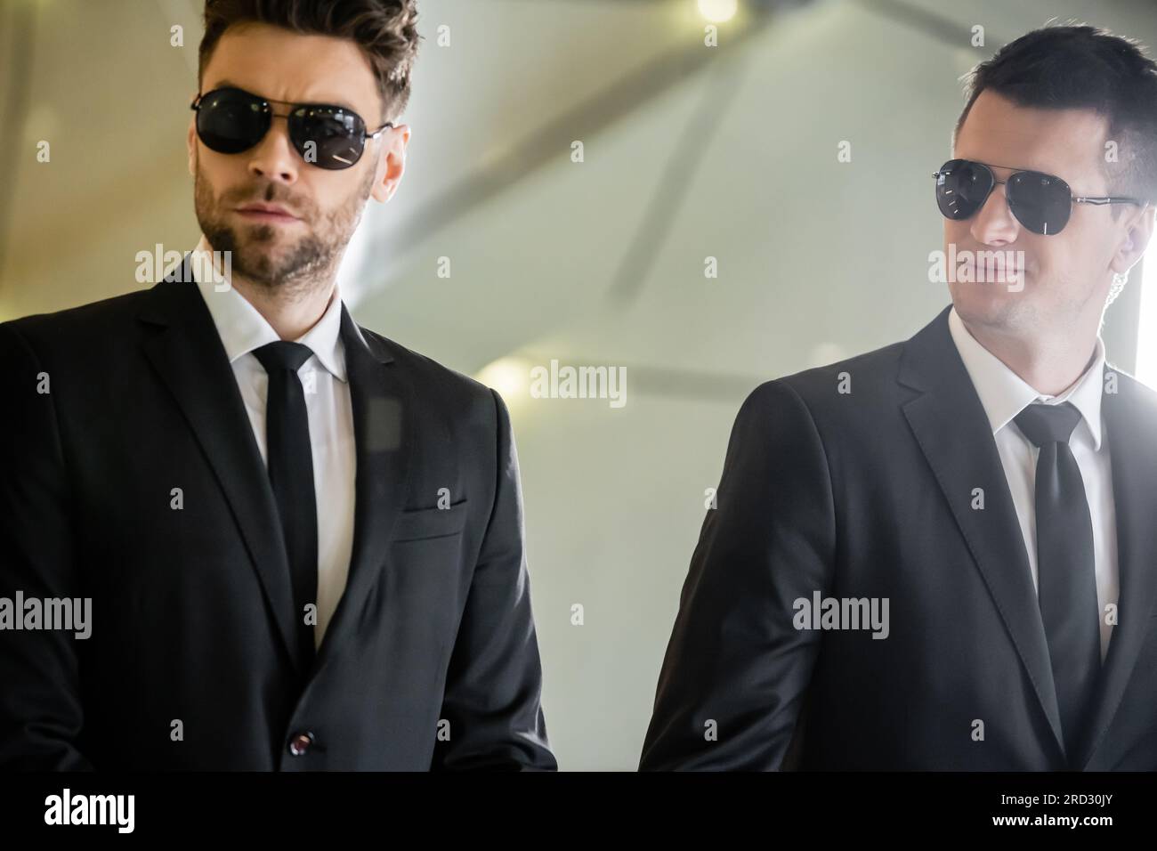 security management, two handsome men in formal wear and sunglasses