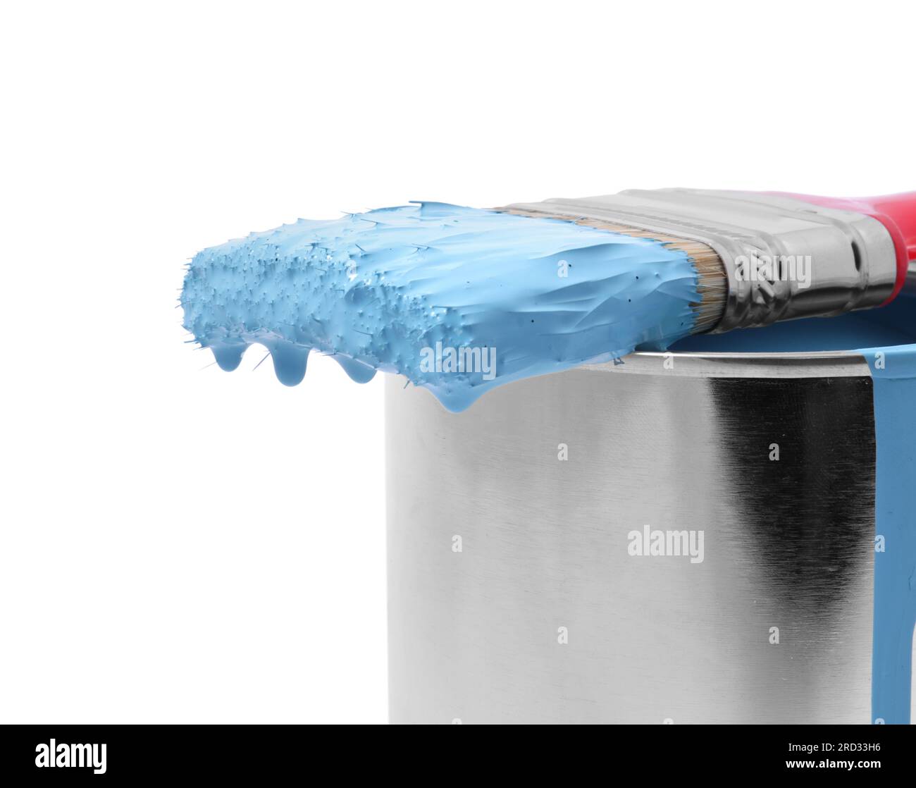 Can of light blue paint and brush on white background, closeup Stock