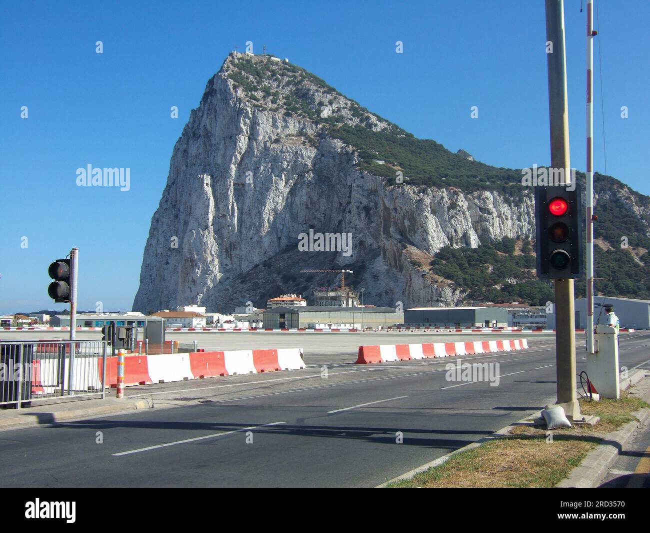 View of the border crossing to the Rock of Gibraltar. Traffic light and barrier at the airport taxiway of Gibraltar Stock Photo