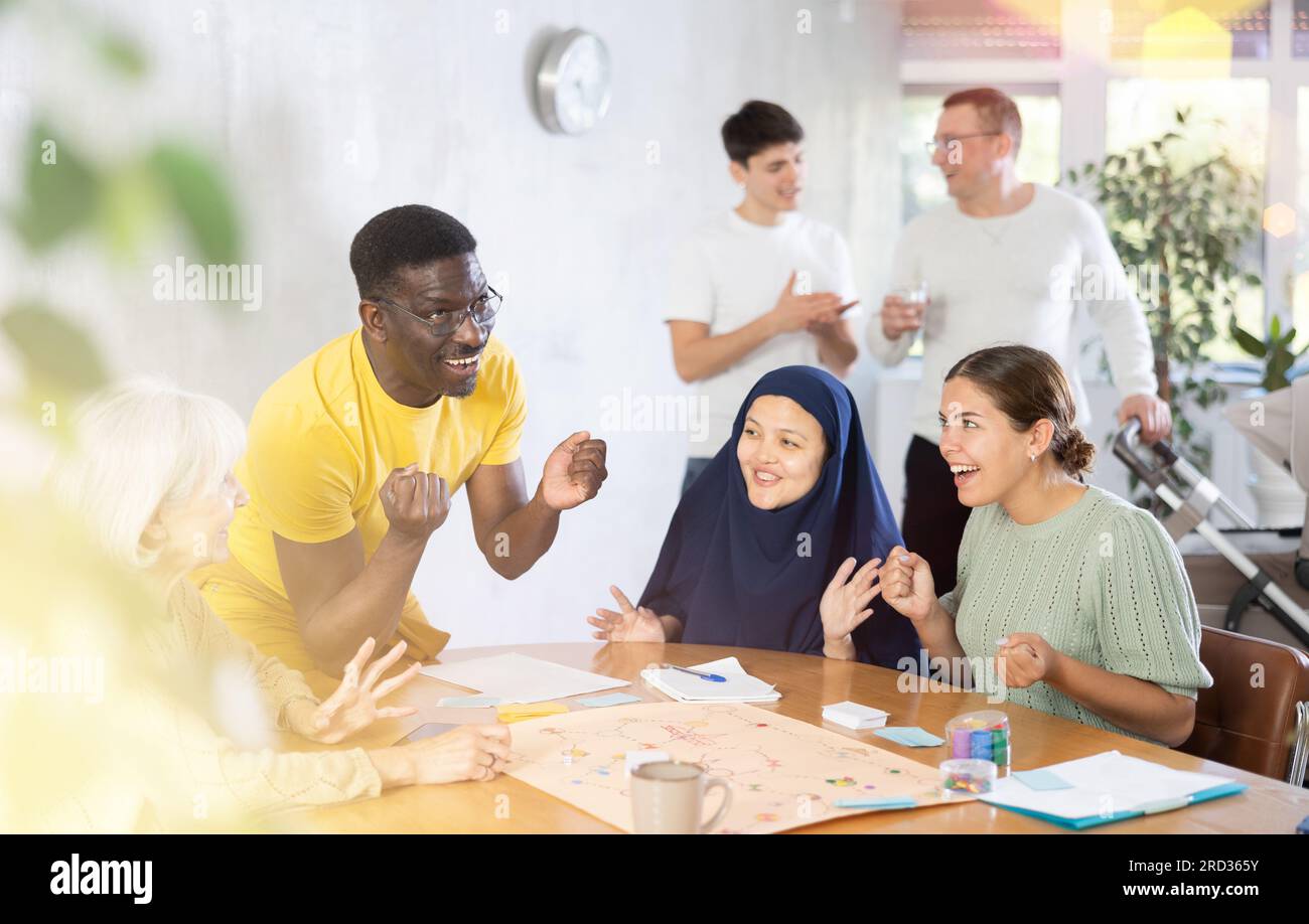 Multinational Person Group of multinational people playing board game Stock Photo - Alamy