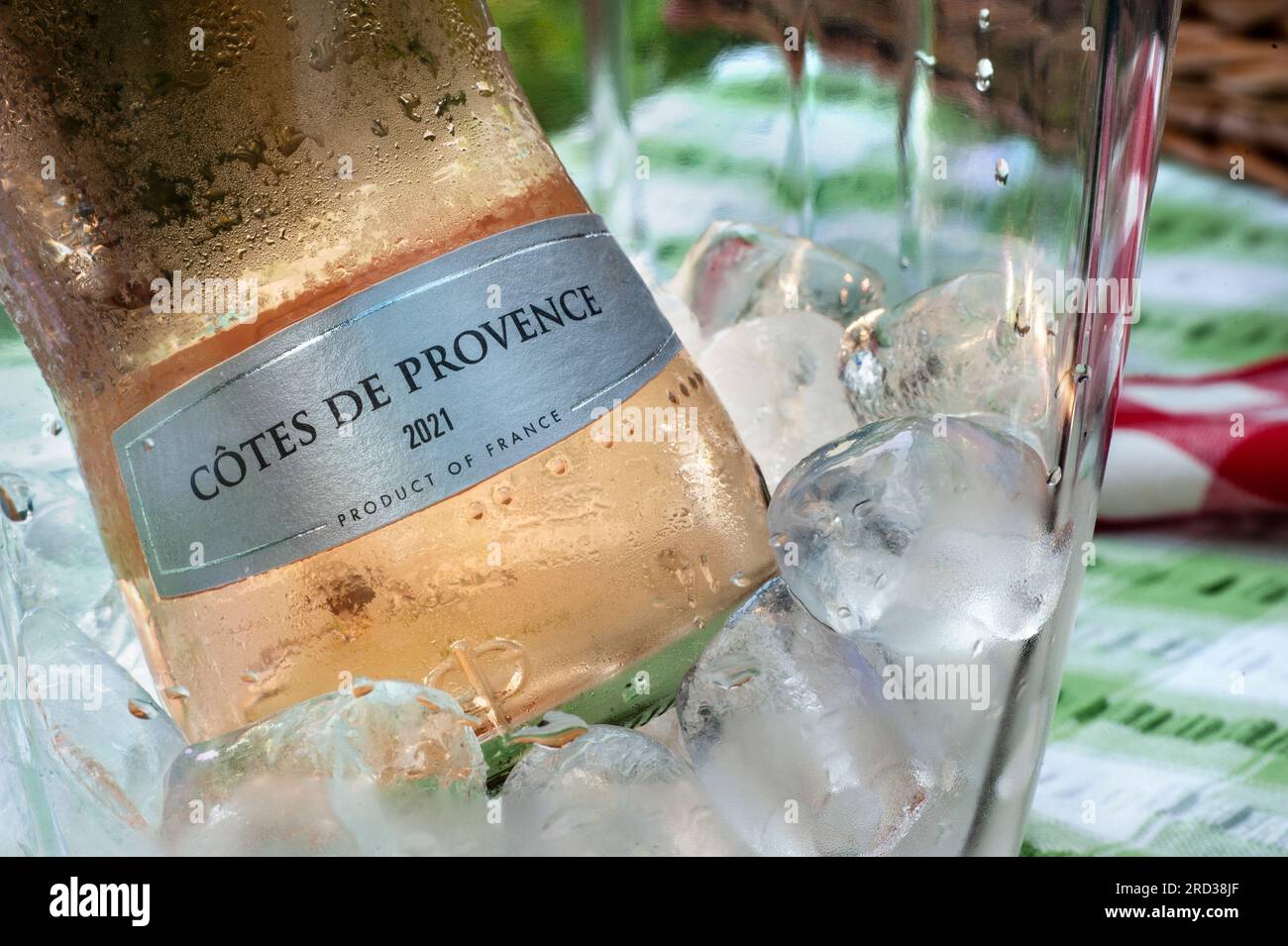 Cotes de Provence French Rosé 2021 wine bottle with label on ice in wine chiller cooler on alfresco outdoor picnic table Stock Photo