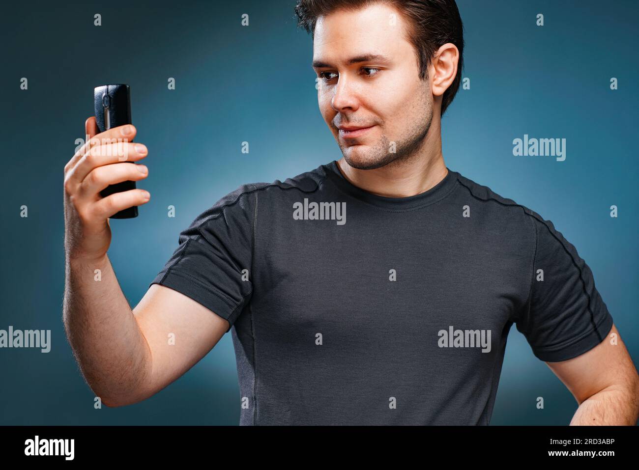 Young handsome man taking selfie portrait on gray wall background Stock Photo