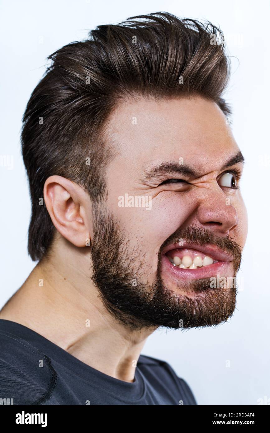 Young crazy danger man emotional portrait on white background Stock Photo