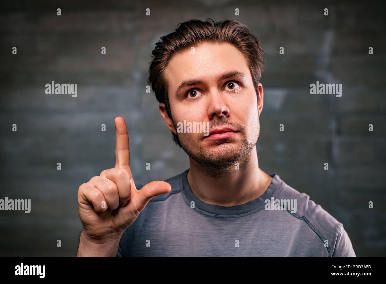 Young handsome man with idea portrait on gray wall background Stock Photo