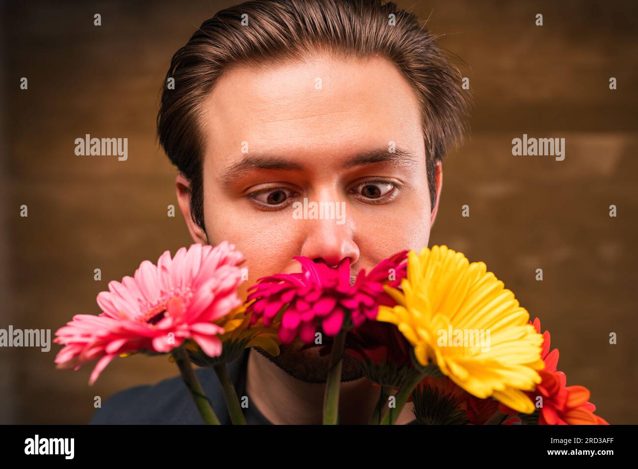 Young man smell flowers portrait Stock Photo