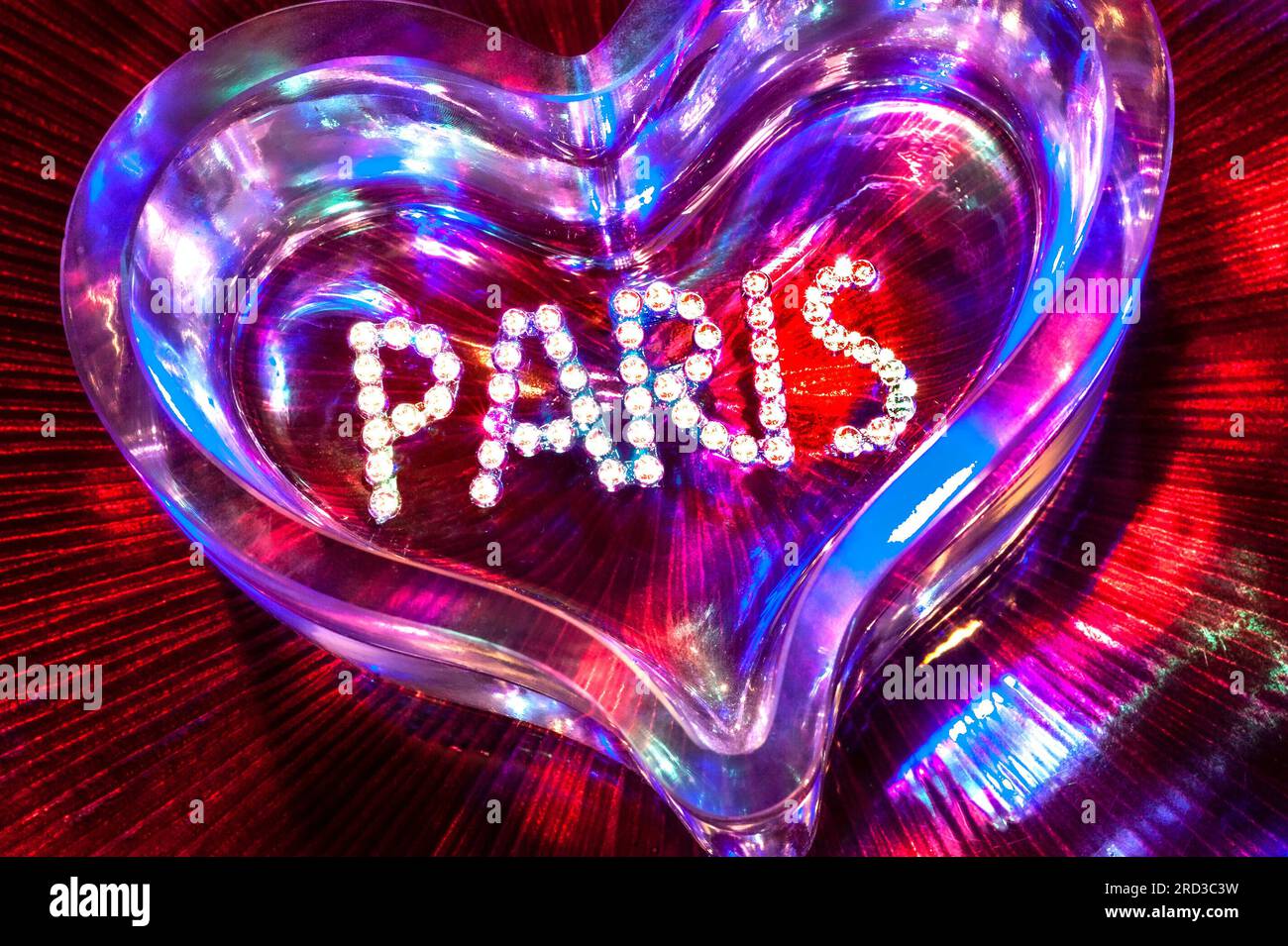 PARIS LOVE FUN NIGHT CONCEPT NIGHTCLUB NIGHTLIFE MONTMARTRE PIGALLE SHOWTIME CABARET CLUB diamonds crystal glass heart with mixed colour lighting in fun clubbing party theatre disco show French concept Paris France Stock Photo