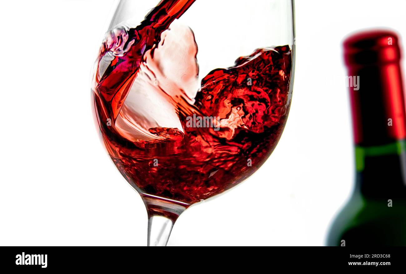 RED WINE TASTING ENJOYING Pouring red wine into a wine glass in