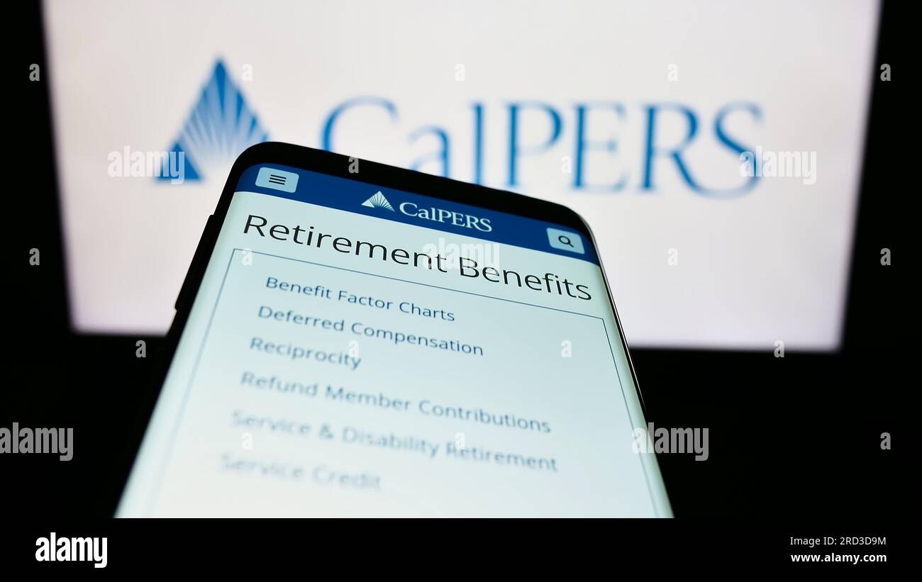 Mobile phone with website of Californian retirement system CalPERS on screen in front of logo. Focus on top-left of phone display. Stock Photo