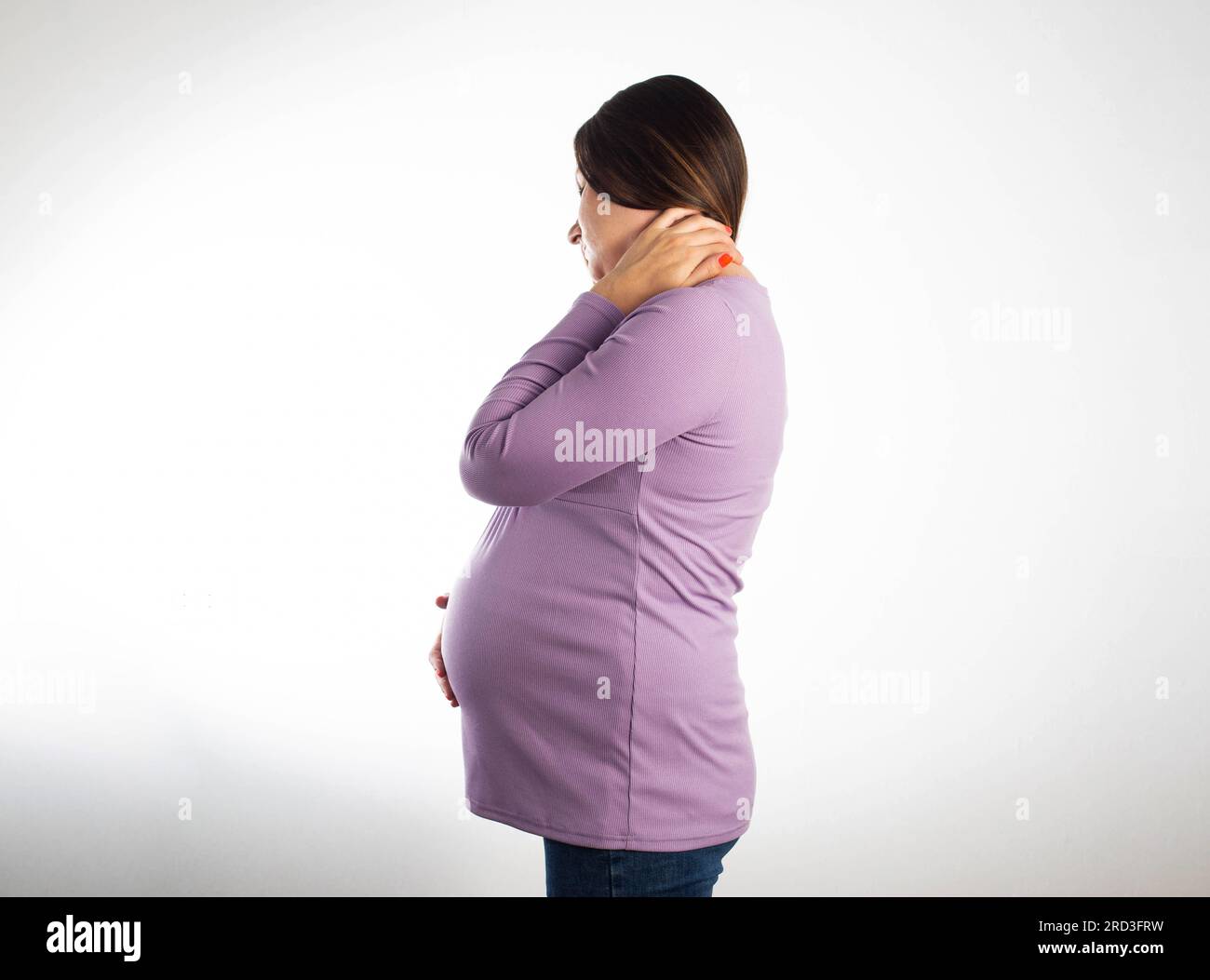 Neck pain in a pregnant girl in a purple blouse on a white background ...