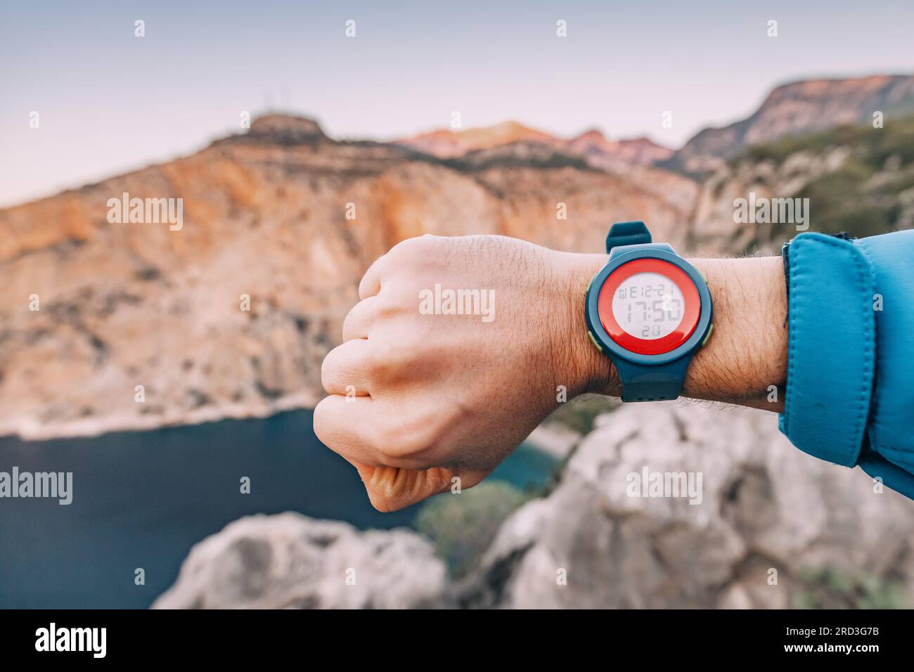 Hiker hand with smart wrist watch clocks outdoors Stock Photo