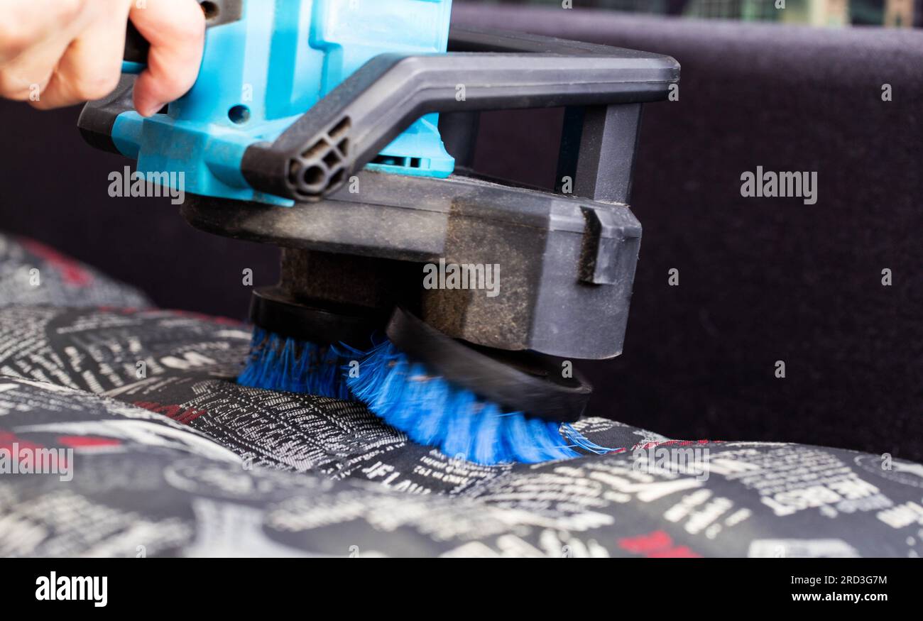 Dry cleaning of the sofa with a special electric brush to raise the
