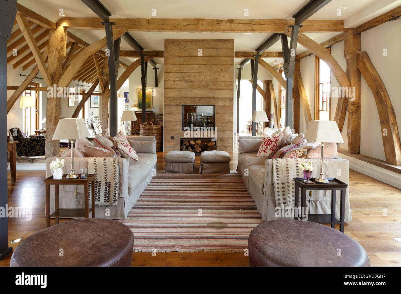 Barn conversion interior timer frame & beams. Wood floor and furniture