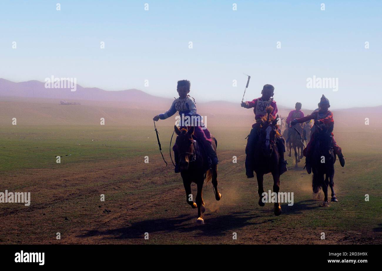 Asia Mongolia Naadam Festival or Eriin gurvan naadam boys on horseback during the festival