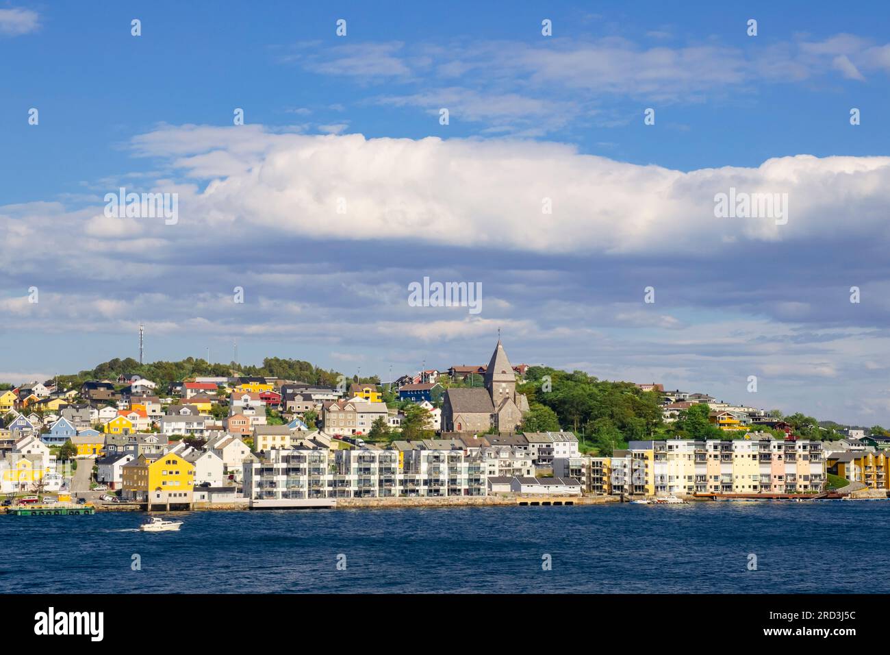 View across harbour to modern waterfront buildings and Nordlandet kirke or North Country Church on Nordlandet island. Kristiansund, Norway, Europe Stock Photo