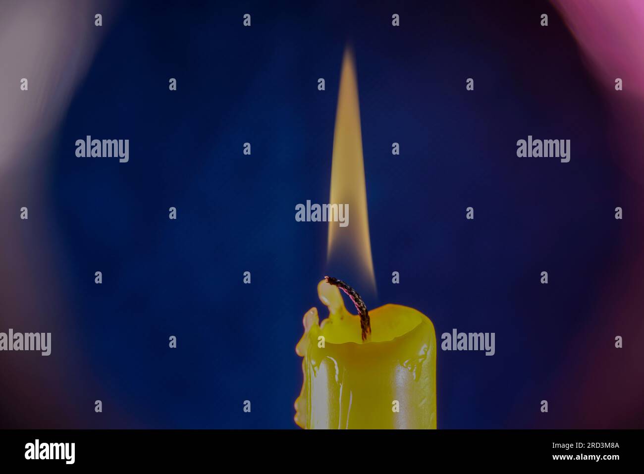 candle with smoke and flame photographed in the studio with color foils