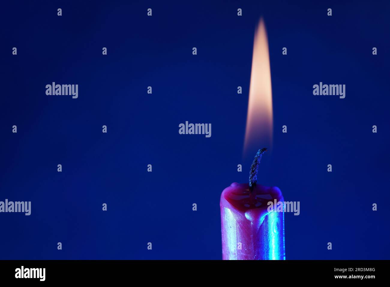 candle with smoke and flame photographed in the studio with color foils