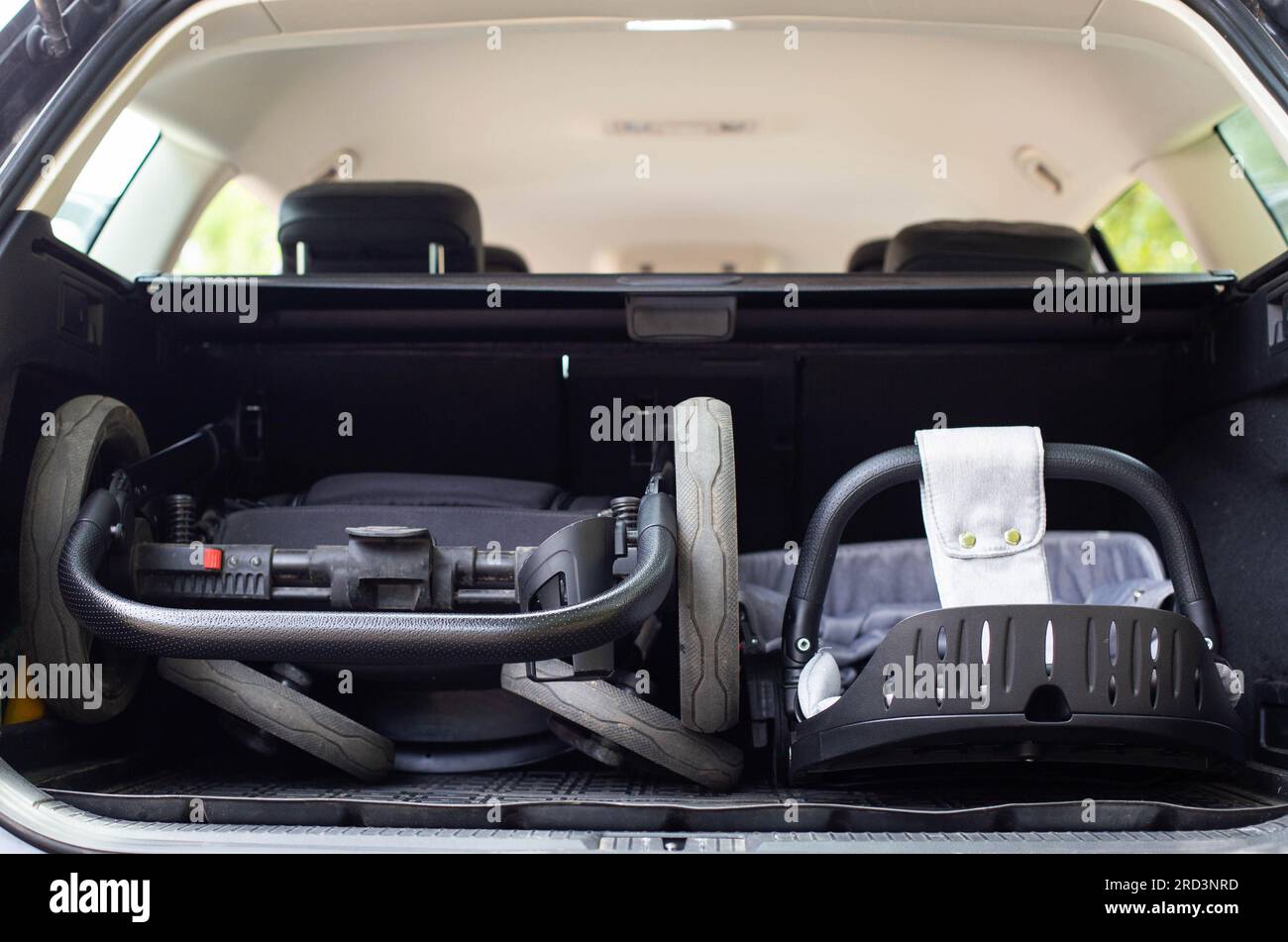 transporting a baby stroller in the trunk of a car when folded Stock