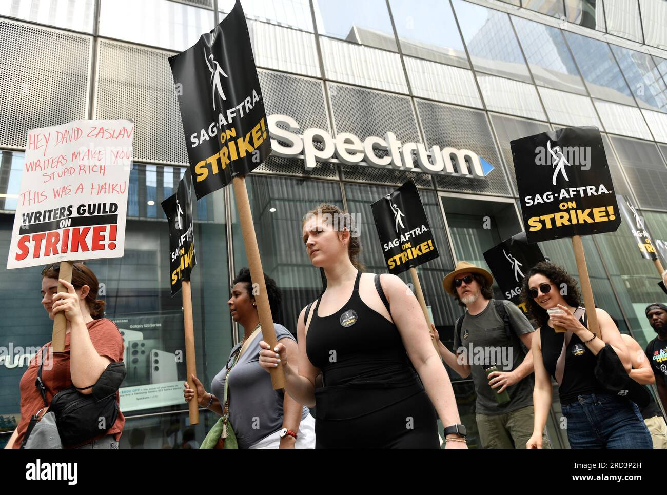 Picketers carry signs outside Amazon and HBO studios on Tuesday, July