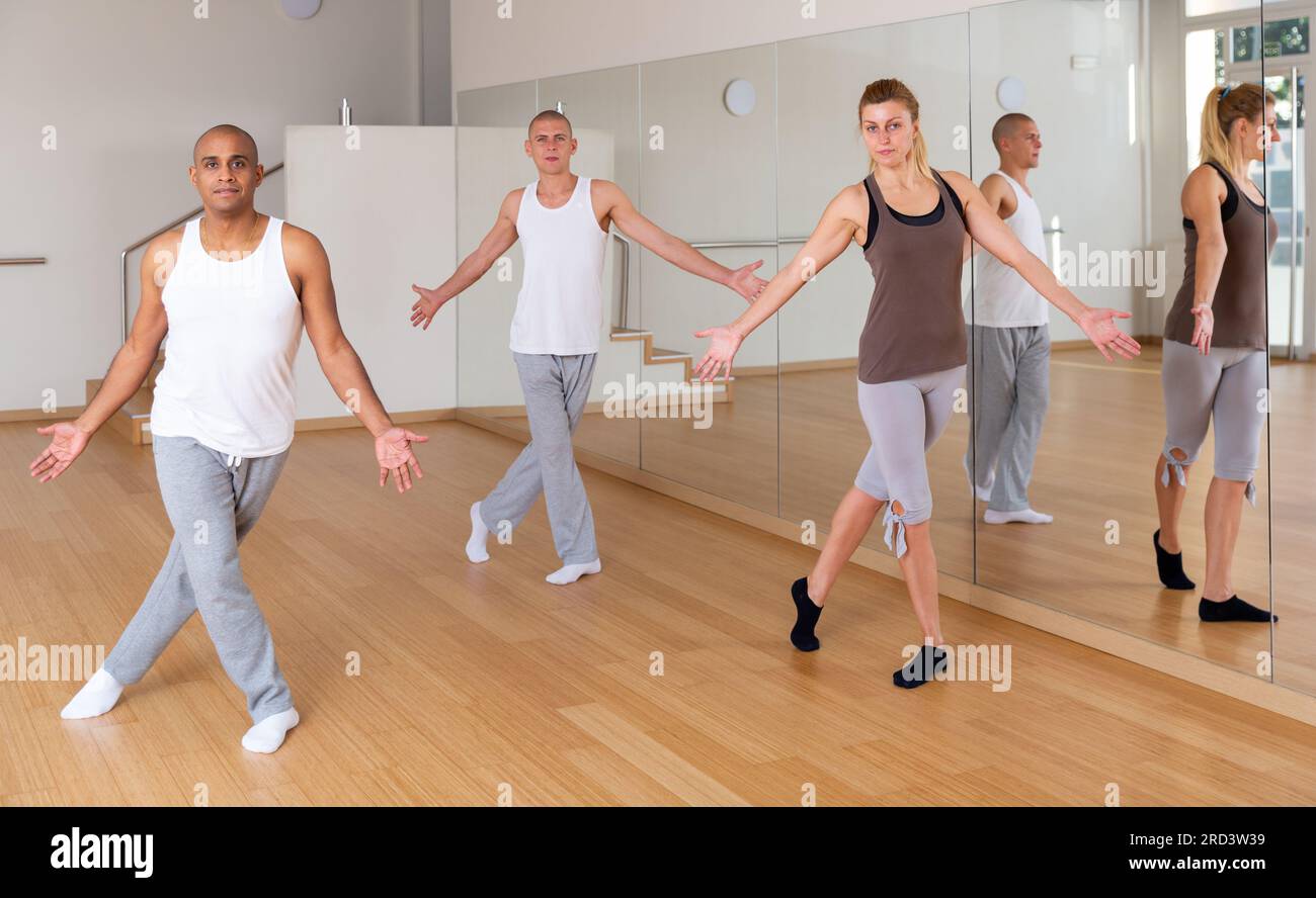Young adults practicing dance movements in choreography class Stock Photo