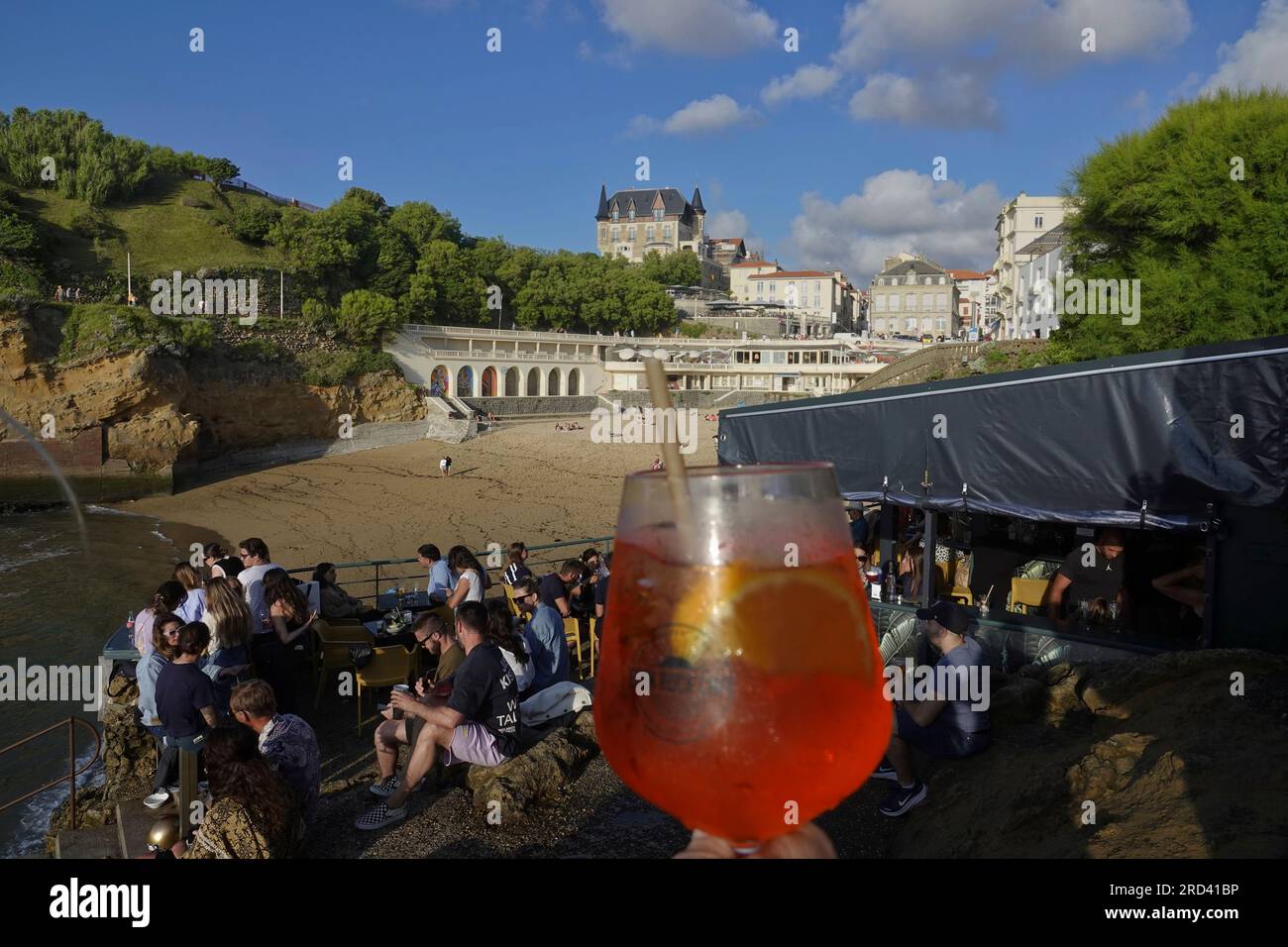 Biarritz, France, July, 2023 As the sun goes down revellers meet at the ...
