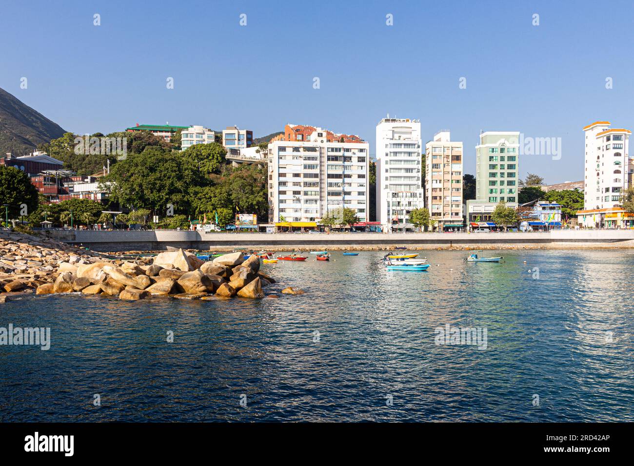 The rocky shoreline, promenade and high rise buildings of Stanley Town in Hong Kong,China - image taken from the Wooden Pagoda Stock Photo