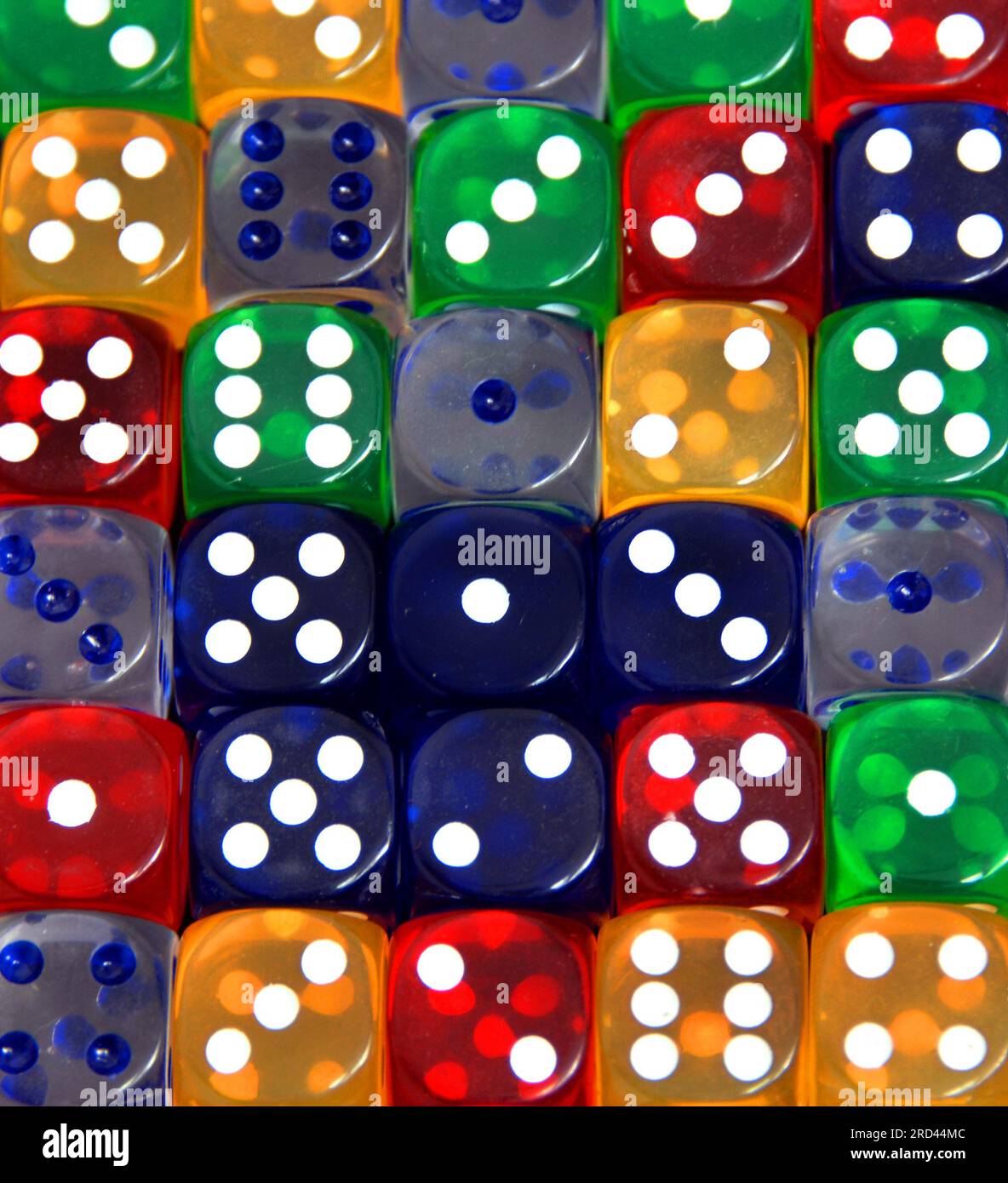 Dice in red, green, blue, yellow and clear fill background Stock Photo ...