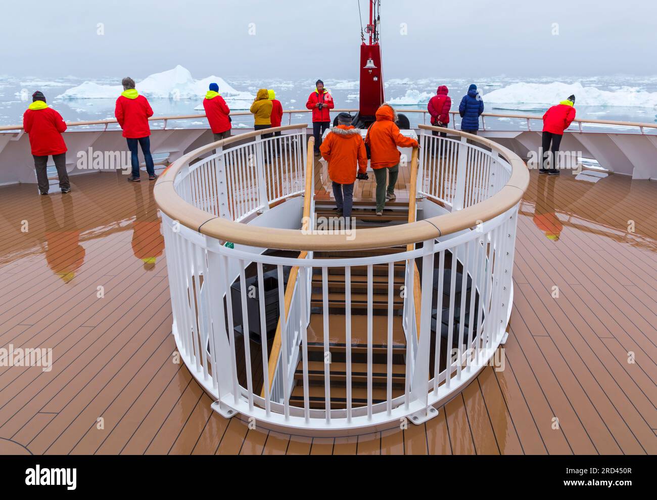 Tourists on desk of Hurtigruten MS Fridtjof Nansen cruise ship cruiseship view the icebergs at Disko Bay, West Greenland in July Stock Photo