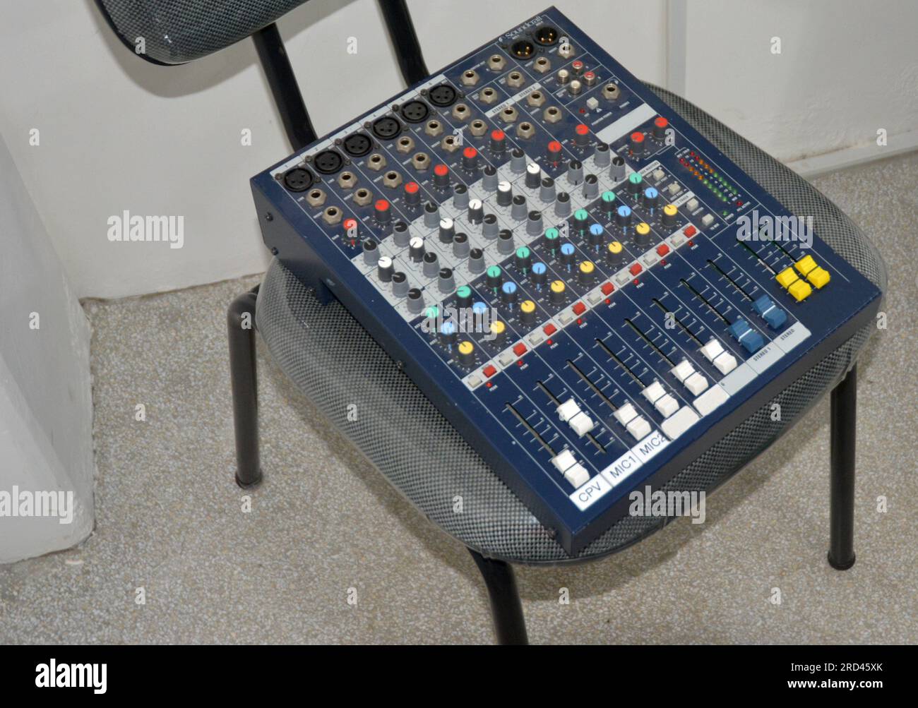 Sound music mixer control panel, placed on top of chair, Brazil, South America, top-down view, zoom style, selective focus, blurred background Stock Photo