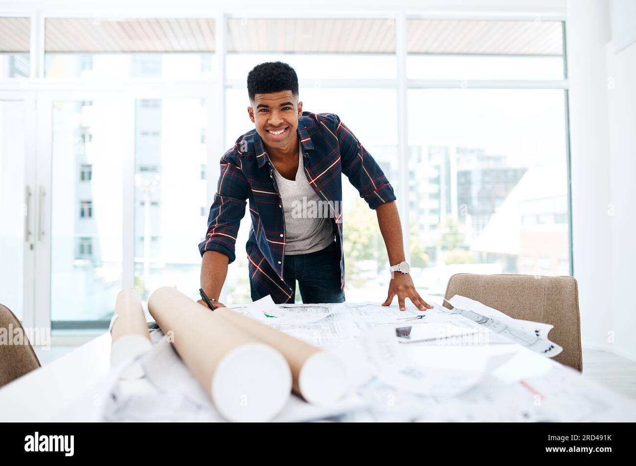 At the head of the design helm. Portrait of a young man going over ...