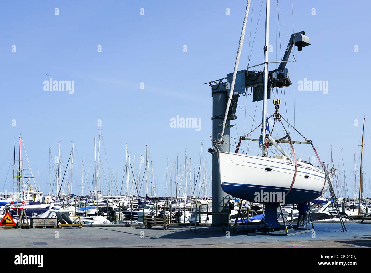 The yacht lifted ashore by a sailboat lift for the maintenance of the