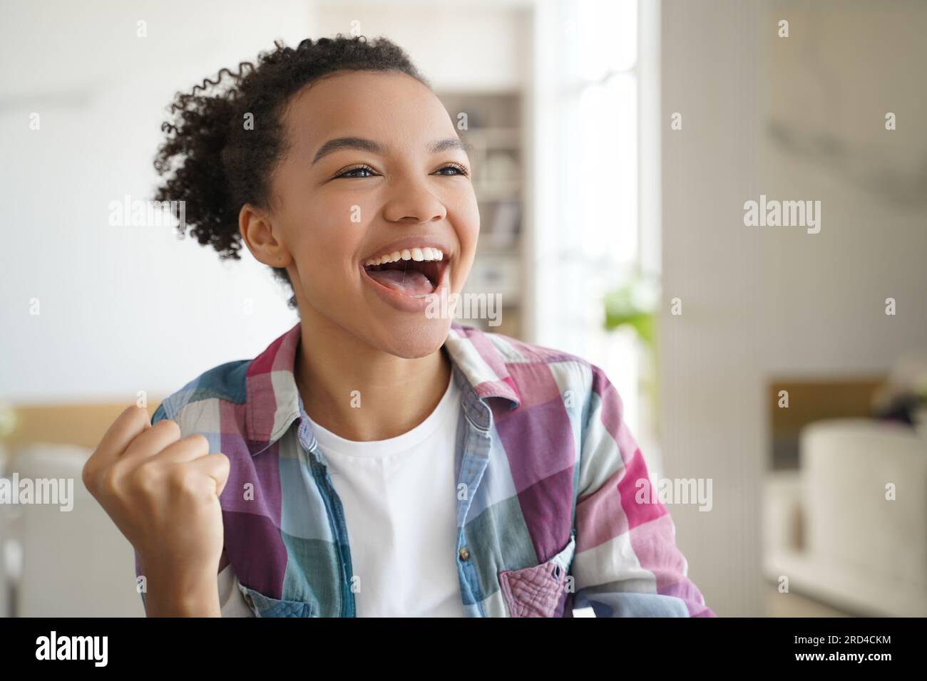 Ecstatic teen girl celebrates personal achievement,