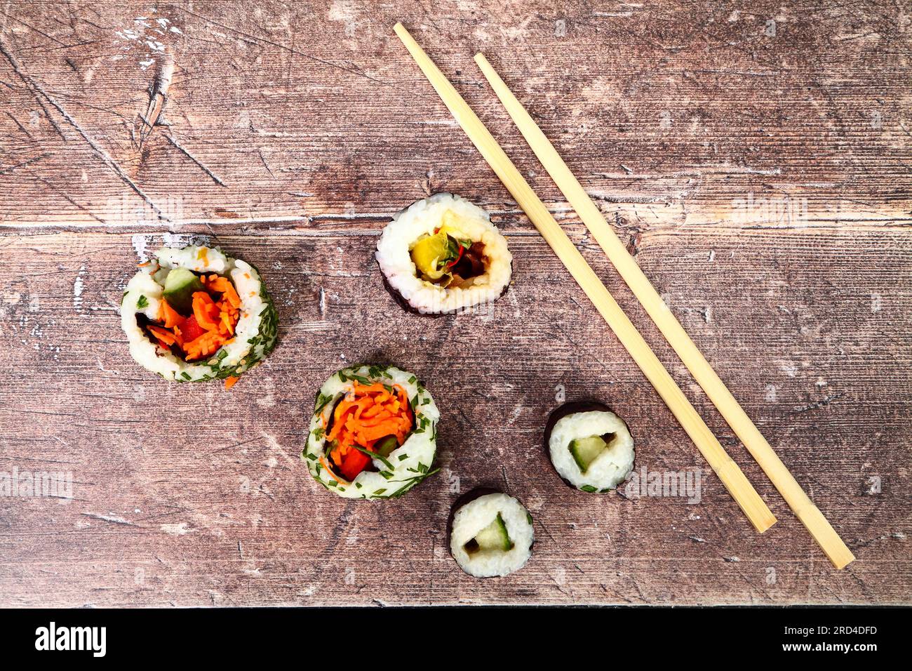Sushi rolls and chopsticks on a wood table Stock Photo
