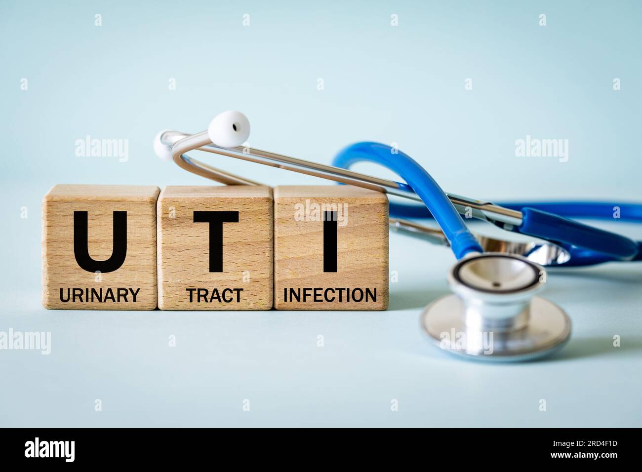 Medical stethoscope and wooden blocks with the medical abbreviation UTI