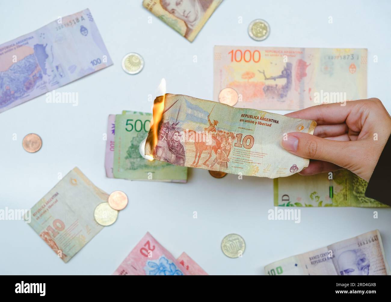 Argentine Pesos Setting On Fire. Concept: collapse of the Argentinian economy and currency devaluation. Stock Photo
