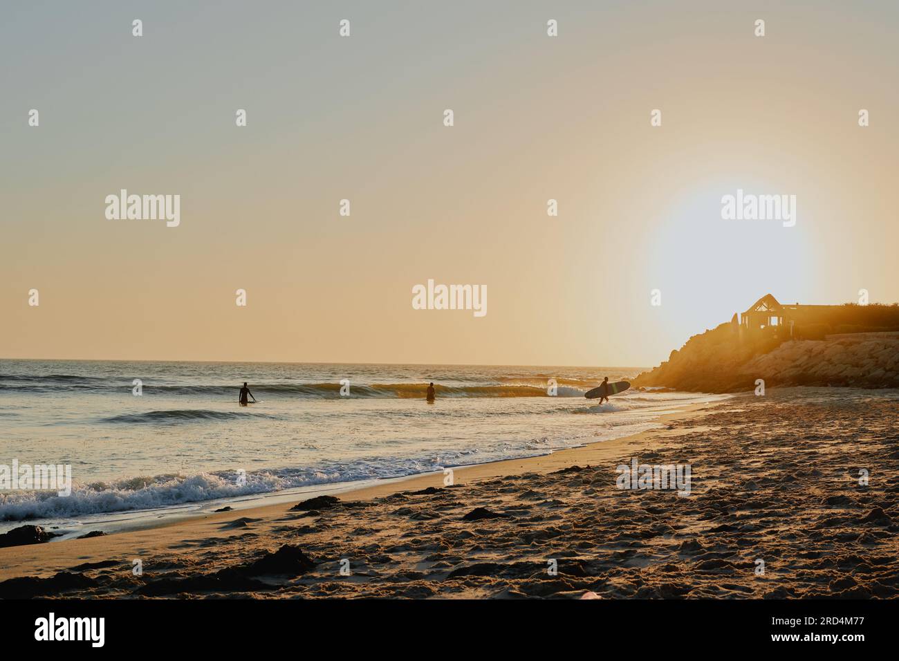 silhouette of a surfer captured at sunset from the brach Stock Photo