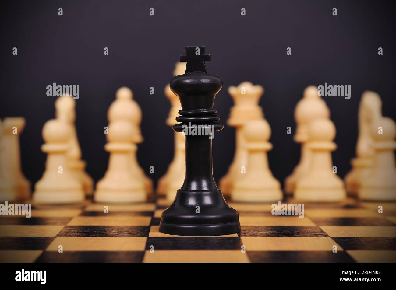 Black Chess King and other chess pieces on chess board Stock Photo