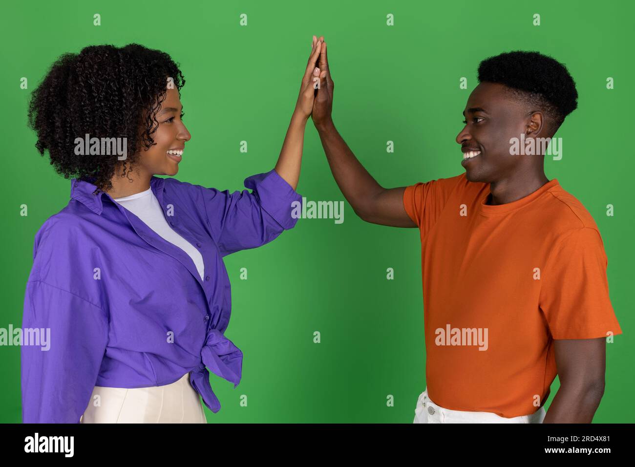 Happy millennial african american couple in casual celebrating victory ...