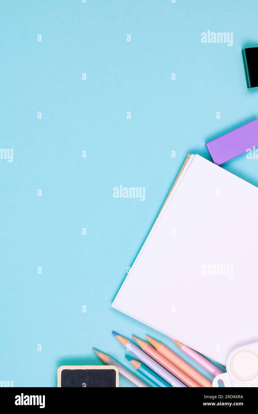 School Color Blue School notebook and various stationery on blue background. Supplies for ...