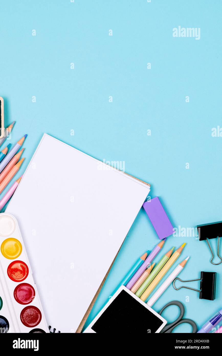 School Color Blue School notebook and various stationery on blue background. Supplies for ...