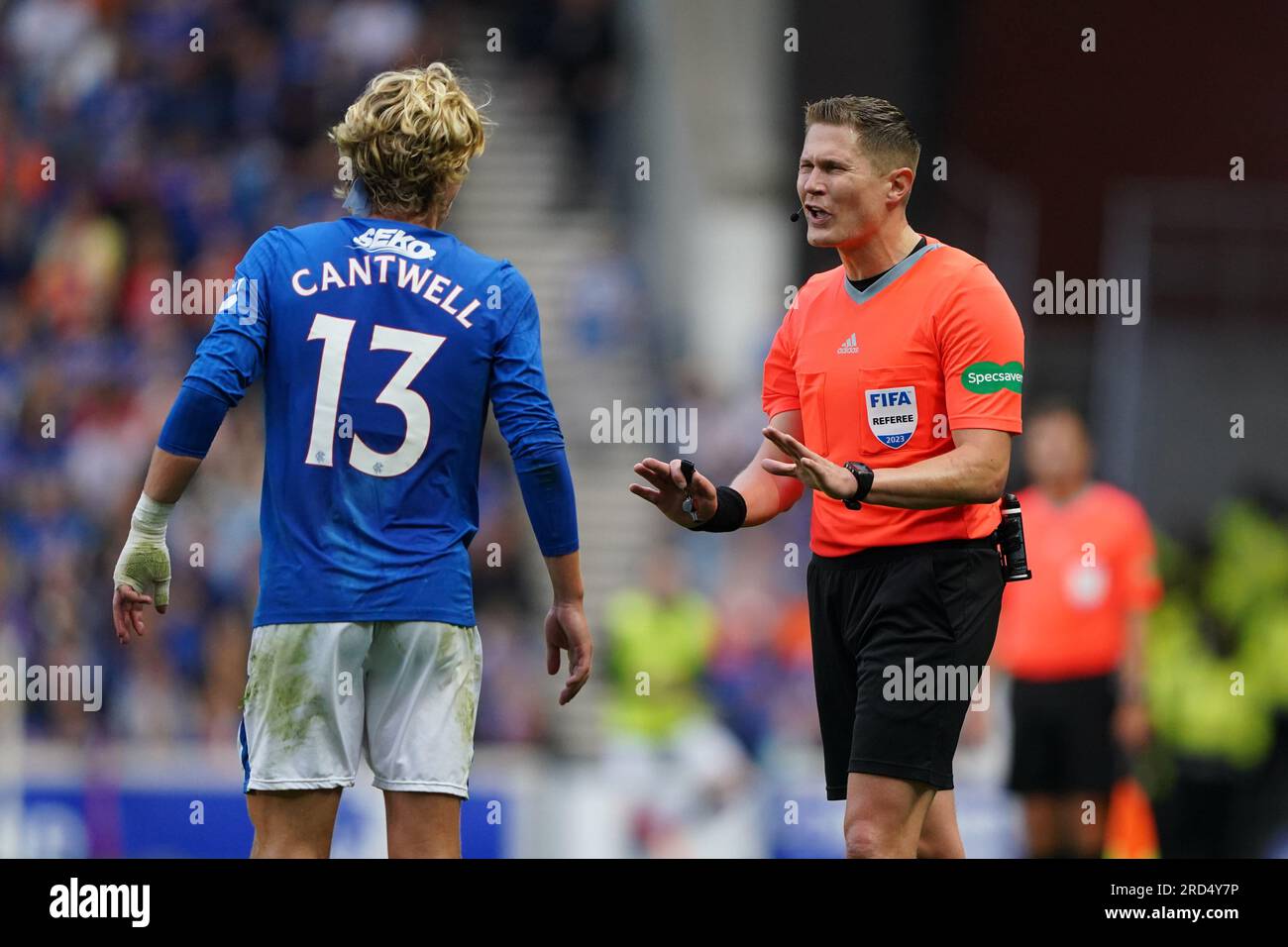 Referee David Dickinson (right) interacts with Rangers' Todd Cantwell