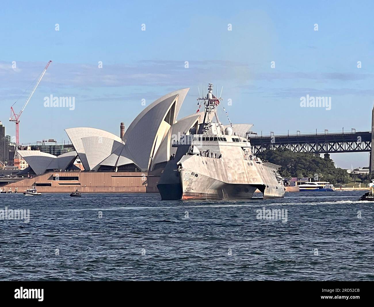 Sydney, Australia. 18th July, 2023. The U.S. Navy Independence-variant littoral combat ship USS Canberra passes the iconic Sydney Opera House as it arrives in Sydney Harbor for a commissioning ceremony, July 18, 2023 in Sydney, Australia. The USS Canberra, namesake ship of the capitol of Australia, arrive ahead of the formal commissioning on July 22. Credit: Julie Ann Ripley/Planetpix/Alamy Live News Credit: Julie Ann Ripley/Planetpix/Alamy Live News Credit: Planetpix/Alamy Live News Stock Photo